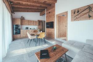 a living room with a couch and a table at Chalets Resort in Cínovec