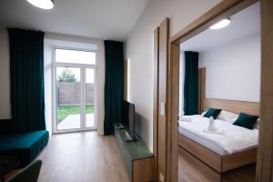 a bedroom with a bed and a large window at One Eleven 111 in Liptovský Mikuláš