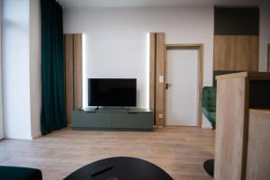 a living room with a flat screen tv on a cabinet at One Eleven 111 in Liptovský Mikuláš