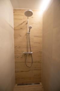 a shower in a bathroom with a wooden wall at One Eleven 111 in Liptovský Mikuláš +26 photos