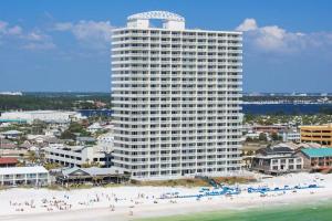 a large building on the beach with people on the beach at Seychelles Beach Resort 2004 in Panama City Beach