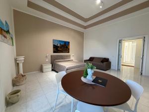 a living room with a table and a couch at Vesuvian Tales in San Giorgio a Cremano