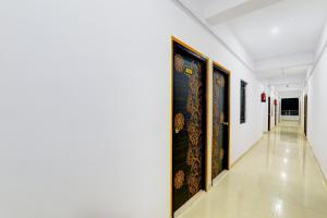a hallway with paintings on the walls at Super Hotel O Kadam Ghat Near Ashok RajPath in Patna