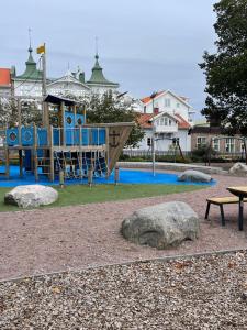 a playground in a park with a slide at Marstrand in Marstrand