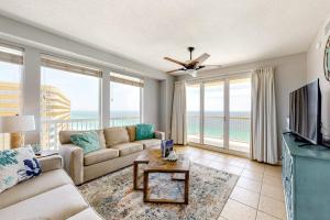 a living room with a couch and a television at Seychelles Beach Resort 2001 in Panama City Beach