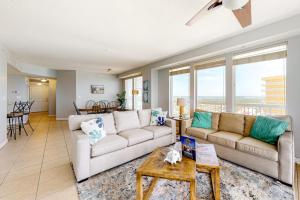a living room with two couches and a table at Seychelles Beach Resort 2001 in Panama City Beach +20 photos