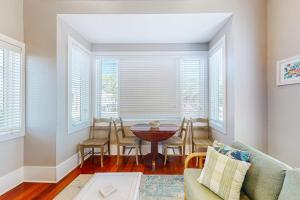 a living room with a table and chairs and windows at Sunshine Haven in Carrabelle