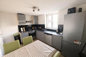 a kitchen with a table and chairs and a table and a table and a kitchen at Ferienwohnung AyNa 3, direkt an der Schweizer Grenze in Bad Säckingen