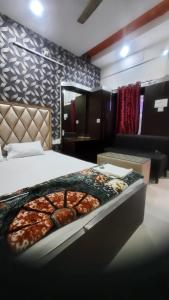 a bedroom with a bed with a pizza on it at Hotel Savera in Rānchī