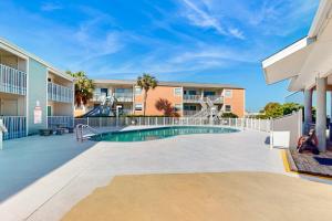 a swimming pool in a courtyard of a apartment building at Villas on the Gulf K-2 in Pensacola Beach