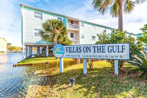 a sign for villas on the gulf in front of a building at Villas on the Gulf K-2 in Pensacola Beach