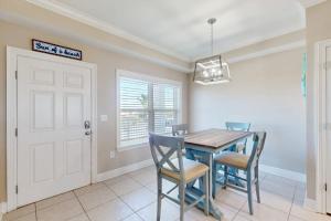 a dining room with a wooden table and chairs at Tranquil Harbour #211 in Mexico Beach