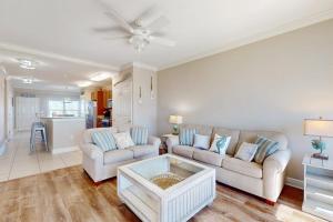 a living room with a couch and a table at Tranquil Harbour #211 in Mexico Beach