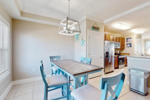a kitchen with a dining room table and chairs at Tranquil Harbour #211 in Mexico Beach +22 photos