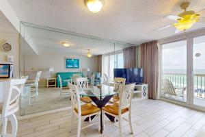 a dining room with a glass table and chairs at Pelican Beach Resort 502 in Destin