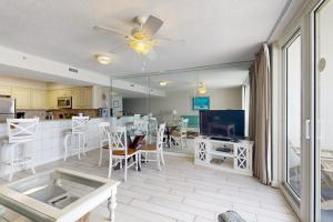 a living room with a kitchen and a dining room at Pelican Beach Resort 502 in Destin
