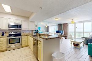 a large kitchen with a view of the ocean at Pelican Beach Resort 502 in Destin +34 photos