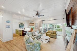 a living room with a couch and a table at Sunset & Smiles in St. George Island