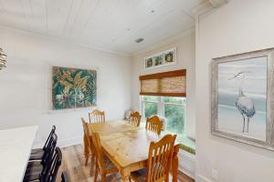 a dining room with a wooden table and chairs at Sunset & Smiles in St. George Island