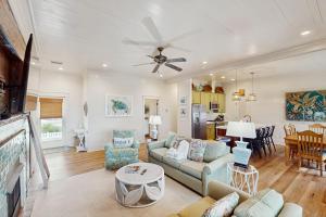 a living room with a couch and a table at Sunset & Smiles in St. George Island