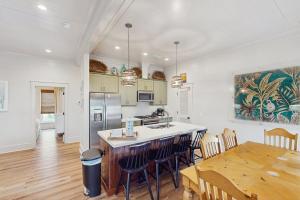 a kitchen and dining room with a table and chairs at Sunset & Smiles in St. George Island +14 photos