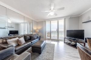 a living room with a couch and a flat screen tv at Inn at Summerwind 0602 in Navarre