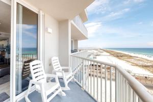 a balcony with two chairs and a view of the beach at Inn at Summerwind 0602 in Navarre