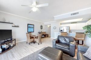 a living room with a couch and a table at Inn at Summerwind 0602 in Navarre +16 photos