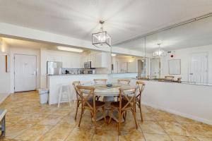 a large kitchen with a table and chairs in it at Pelican Beach Resort 415 in Destin