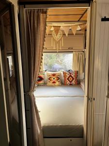 a bedroom in an rv with a window at Glamping Karavan u Konopiště in Chrášťany +44 photos
