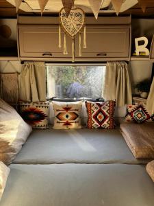 a room with pillows and a bed in a rv at Glamping Karavan u Konopiště in Chrášťany