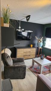 a living room with a couch and a table at CasaLuca in Hellevoetsluis