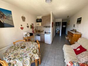 a kitchen and a living room with a table at Apartment with stunning mountain views in Barcelonnette