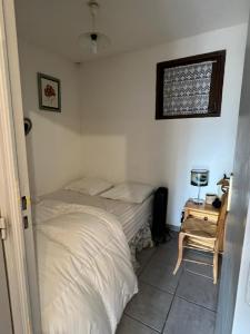 a bedroom with two beds and a table with a lamp at Apartment with stunning mountain views in Barcelonnette