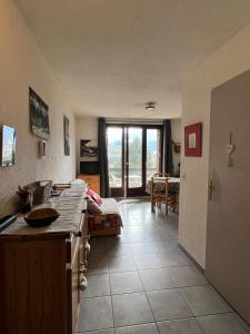 a kitchen with a counter and a living room at Apartment with stunning mountain views in Barcelonnette
