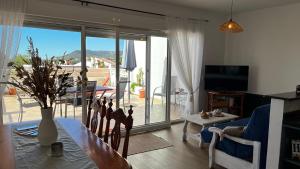 a living room with a table and a large glass door at Las estrellas in Peniscola