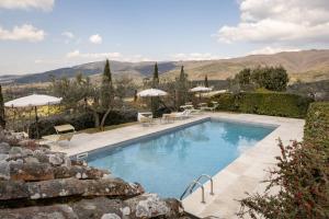 a swimming pool with a view of the mountains at Agriturismo Santo Stefano in Polvano