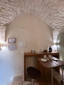 a room with a wooden table and a table and chair at La Piazzetta - Luxury Homes in Ceglie Messapica