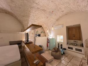 a kitchen with a bed and a refrigerator in a room at La Piazzetta - Luxury Homes in Ceglie Messapica
