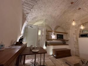 a kitchen with a sink and a table in a room at La Piazzetta - Luxury Homes in Ceglie Messapica +7 photos