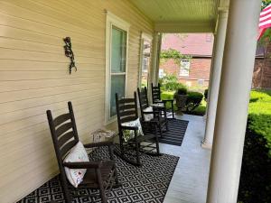 a group of chairs sitting on a porch at Red Rose Inn Bed and Breakfast in Bardstown +29 photos