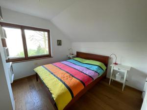 a small bedroom with a bed and a window at Zbilje Lake house in Medvode