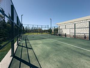 a tennis court with a net on a tennis court at Maison Azen - Moroccan Luxury Stay in Essaouira