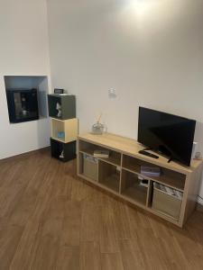 a living room with a wooden entertainment center with a flat screen tv at Antica trave in Provaglio d'Iseo