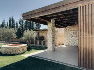 a wooden pavilion in a yard with a stone wall at Maison Azen - Moroccan Luxury Stay in Essaouira