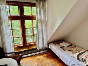 a bedroom with a bed and a large window at Zajazd Rybaki in Płock