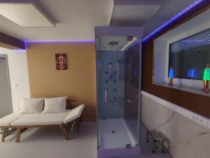 a shower in a room with a couch and a bench at VIP Wellness apartma Immortality in Zgornja Velka