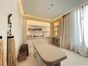 a white room with a bench and a window at Maison Azen - Moroccan Luxury Stay in Essaouira +103 photos