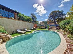 a swimming pool in the backyard of a house at LE PRIEURE - Suites romantiques spa privatif, piscine, jardin, massages proche de Toulouse in Verfeil
