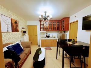a living room with a couch and a table at 727 Anabelle Residence at Marina Spatial Condominium in Dumaguete